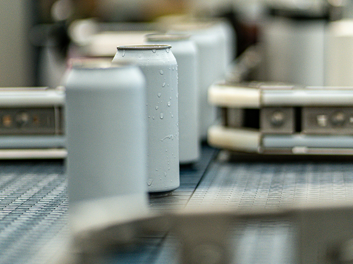 Cans on conveyor machine