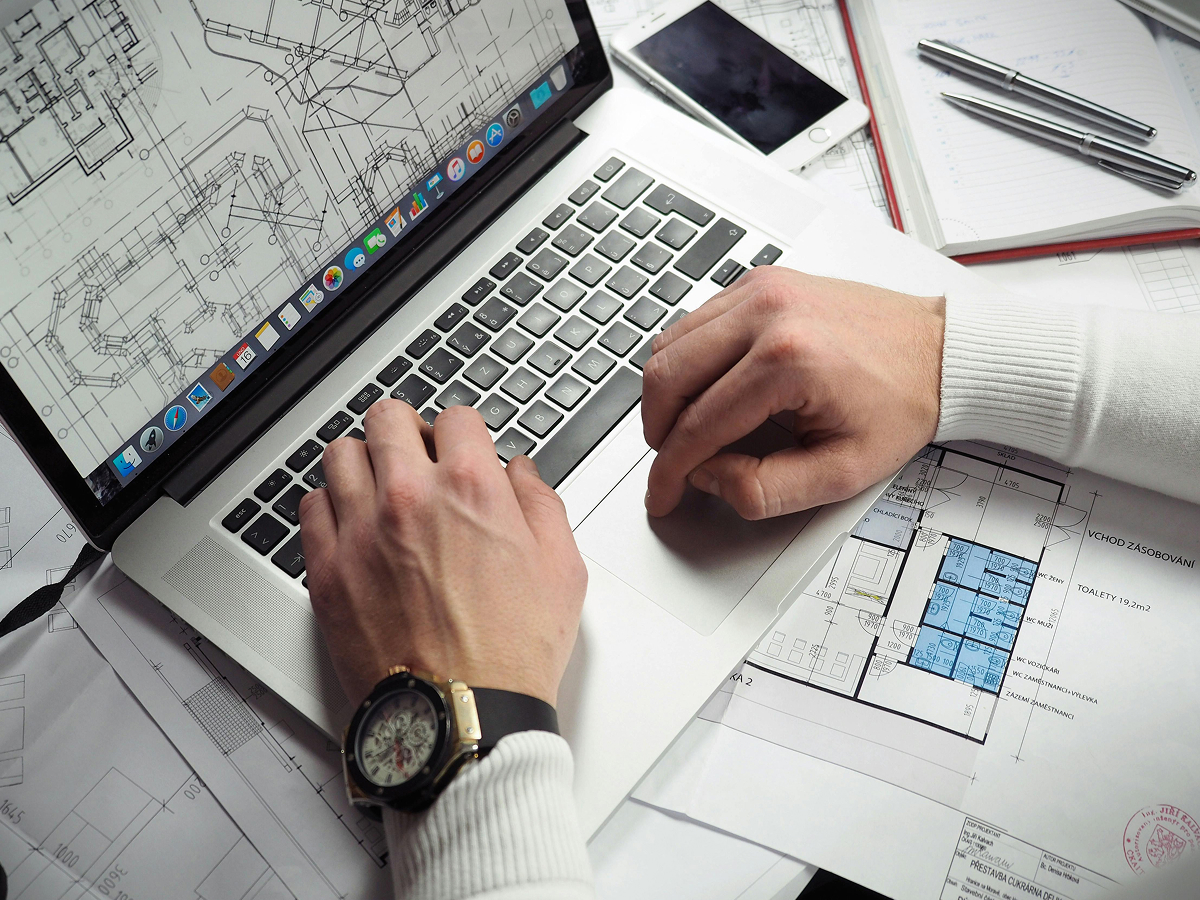 Industrial designer using MacBook