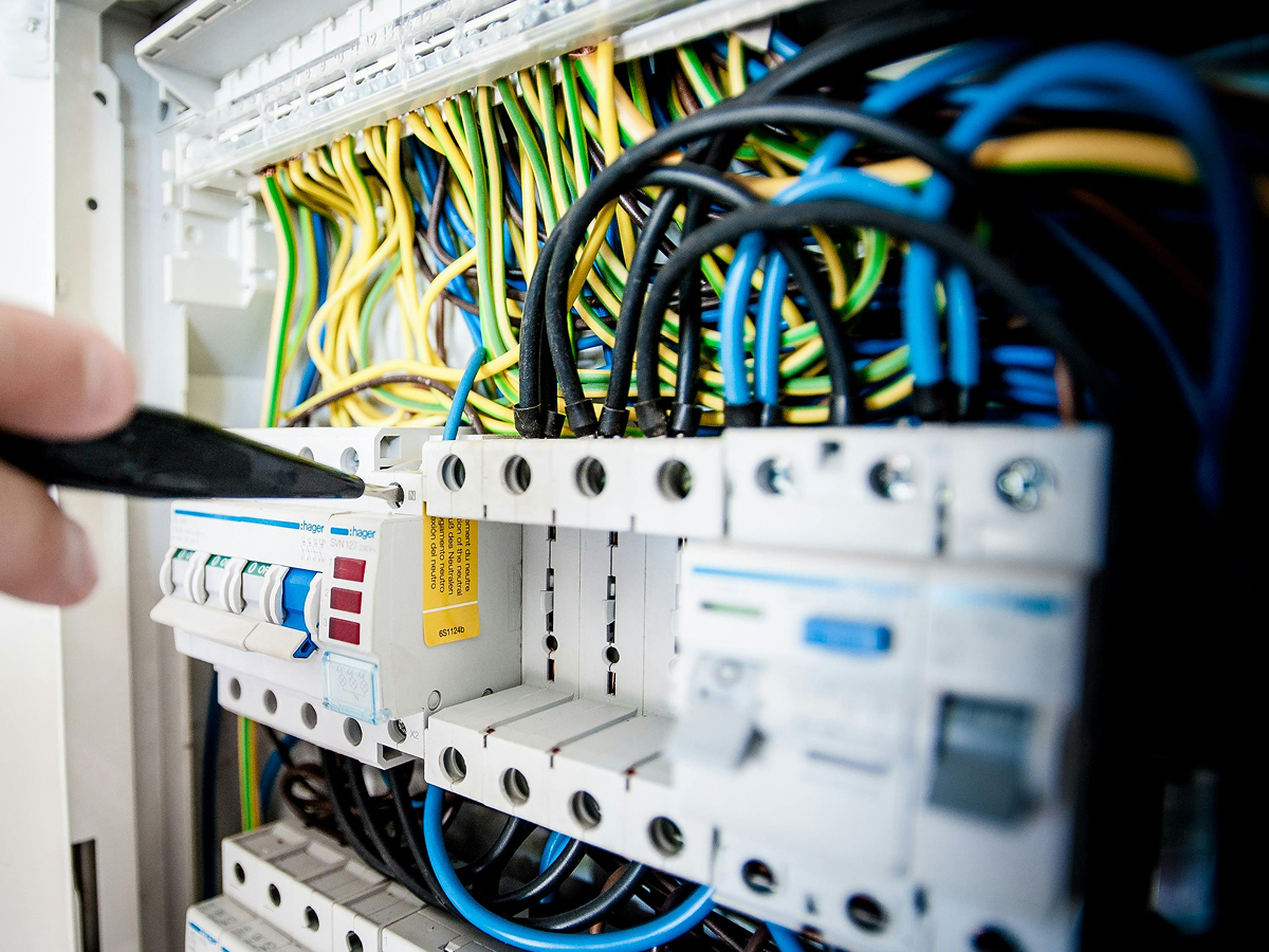 Hand pointing to machine wires